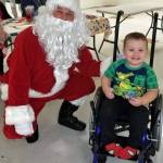 Bentley, who has spina bifida, lives in Westport with his mom, Lisa Carlson. Hes pictured here visiting Santa at last years Raising Awareness event.