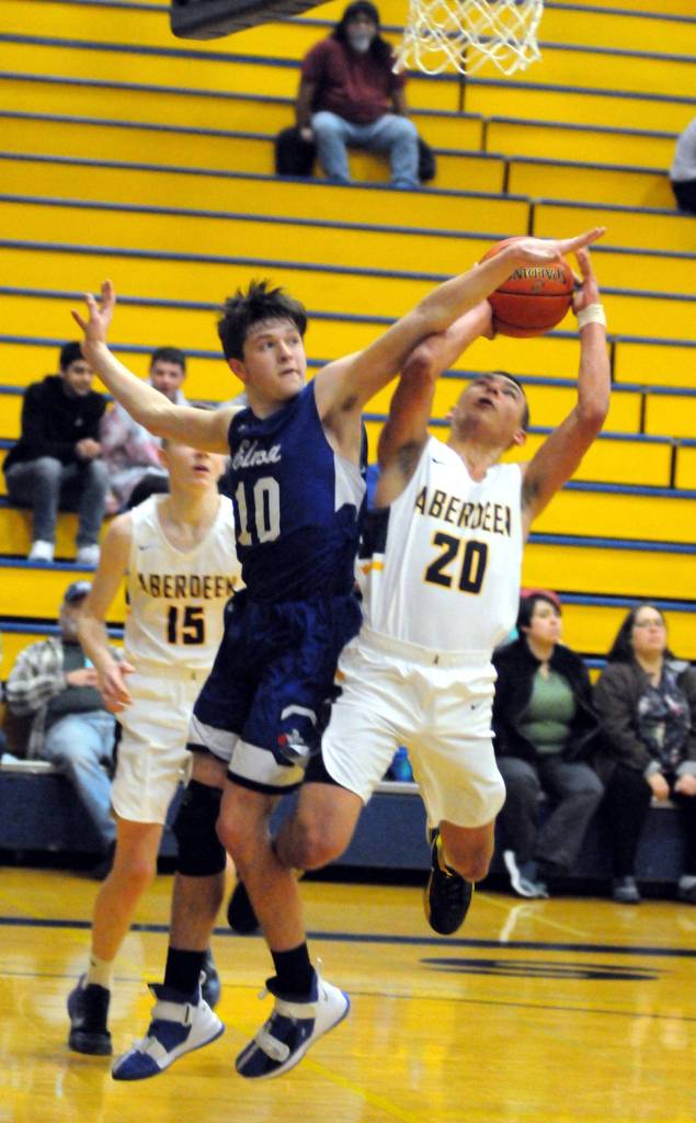 Aberdeens Ethan Morrill (20) is fouled by Elmas Cobey Moore on a drive to the basket in the first half of Aberdeens 53-44 win on Tuesday in Aberdeen. (Ryan Sparks | Grays Habor News Group)