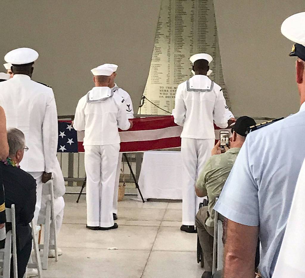 Photo courtesy Teri Mann Whyatt                                Sailors fold the U.S. flag during a ceremony for Lauren Bruner, a USS Arizona survivor and Elma High School graduate, on Dec. 7 in Pearl Harbor, Hawaii. The service was held on the USS Arizona Memorial. Bruner is believed to be the last person to be interred into the ship.