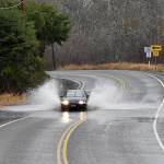 DAN HAMMOCK | GRAYS HARBOR NEWS GROUP                                A car plows through water crossing the roadway a few miles up the Wishkah north of Aberdeen Thursday. Heavy rains and high tides caused some localized flooding in the region, and a flood watch remains in effect in Grays Harbor County through 10 p.m. Sunday.