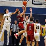 Hoquiams Troy McMinn (21) puts up a shot while being defended by Aberdeens Andrew Troeh (5) and Robert Salomon on Saturday in Aberdeen. (Ryan Sparks | Grays Harbor News Group)