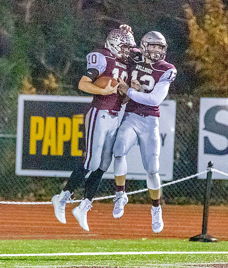 Montesanos Trace Ridgway, left, and Sam Winter celebrate during the Bulldogs state-playoff victory over Meridian on Nov. 16. Both were named the 1A Evergreen League co-MVPs for the 2019 season. (Photo by Shawn Donnelly)