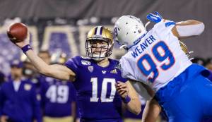 Washington quarterback Jacob Eason (10) passes around the pass rush of Boise States Curtis Weaver (99), completing in a touchdown pass in the first quarter in the Las Vegas Bowl on Saturday, Dec. 21 at Sam Boyd Stadium in Las Vegas. Eason announced on Thursday he will enter the 2020 NFL Draft. (Darin Oswald | Idaho Statesman/TNS)
