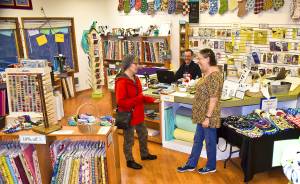 Photo by Scott D. Johnston                                The new owners of Beach Tyme Fabric & Craft Supply in Ocean Shores, Chuck and Gail Anderson (center and right) chat with a new customer, Kelly Osness of Ocean Shores, at the store located at 873 Pt. Brown Ave. NW.