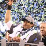 Seattle Seahawks quarterback Russell Wilson raises the Lombardi trophy after a 43-8 victory against the Denver Broncos in Super Bowl XLVIII at MetLife Stadium in East Rutherford, N.J., on Sunday, Feb. 2, 2014. (Tony Overman/The Olympian/MCT)