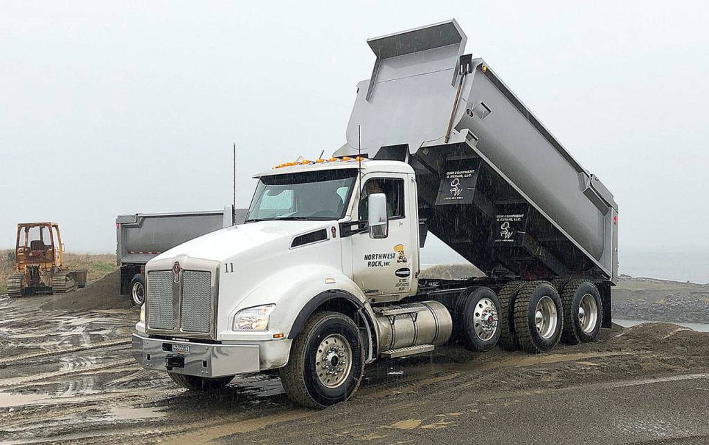 Photos COURTESY ARMY CORPS OF ENGINEERS                                Trucks from Northwest Rock Inc. are dumping sand on the breach fill area of Westports south jetty. Crews are about halfway through a project to shore up the spit between the jetty and the mainland.