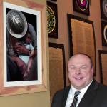 DAN HAMMOCK | GRAYS HARBOR NEWS GROUP                                Hoquiam Mayor Ben Winkelman stands by a photo of his dad, Mario Winkelman, and his youngest brother Bryce taken at Camp Grisdale the year it closed, which hangs in the Jitter House in Hoquiam. The Winkelman family had its roots in the logging camp.