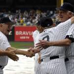 Hall of Famer and former New York Yankees catcher Yogi Berra, second from right, hugs former Yankee pitcher Don Larsen, right, during the 60th annual Old-timers Day introductory ceremony at Yankee Stadium on Saturday, June 24, 2006. Larsen, 90, died Wednesday in hospice in Hayden, Idaho, of esophageal cancer. (James Keivom | New York Daily News/TNS)
