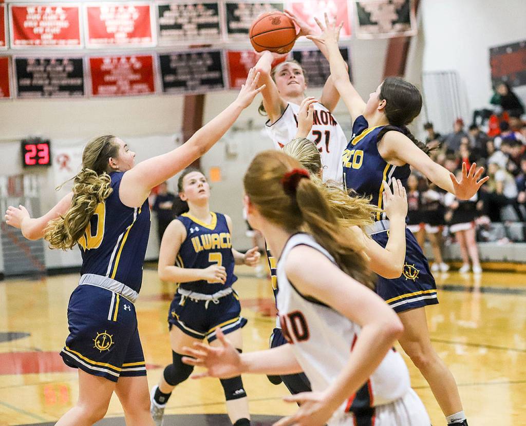 Raymonds Kyra Gardner is swarmed by Ilwaco defenders as she puts up a shot against the Fishermen on Friday in Raymond (Photo by Larry Bale)