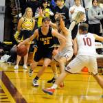 Aberdeens Wyatt Johnson (23) drives the baseline while being defended by Hoquiams Garrett Dick and Ben Estes (10) during the Bobcats 67-64 double-overtime victory on Friday in Hoquiam. (Ryan Sparks | Grays Harbor News Group)