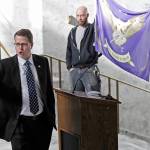 Rep. Matt Shea (left) gestures as he gives a speech in front of the liberty state flag Feb. 15, 2019, at the Capitol in Olympia. (AP Photo/Ted S. Warren)