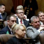 Republican state Rep. Matt Shea (center) sits on the House floor with Republican colleagues during the State of the State address by Gov. Jay Inslee in January 2019 in Olympia. (AP Photo/Elaine Thompson, file)