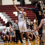 Ryan Sparks | Grays Harbor News Group                                Montesanos Alex Mesquita (33) scores two points while being defended by Forks Trey Baysinger in Thursday in Montesano. Monte won 47-33 and is in sole possession of first place in the 1A Evergreen League.
