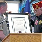 Photos by Rachel Friederich                                David Hodgeboom, right, presents an incarcerated veteran at Stafford Creek Corrections Center with a framed charter for the prisons American Legion post. Hodgeboom is a U.S. Army veteran and serves on the American Legion National Executive Committee.