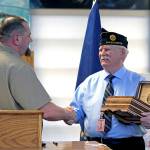 An inmate at the Stafford Creek Corrections Center shakes the hand of American Legion member Frank Sterling, right. Sterling was one of the speakers during the Jan. 15 charter presentation ceremony.