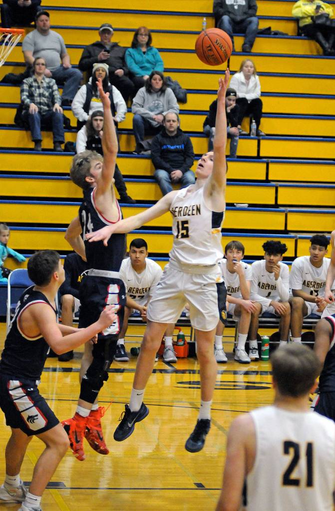 Aberdeen forward Kayden Seibert (15) puts up a shot over Black Hills Weston Ainsworth during Saturdays game at Sam Benn Gym in Aberdeen. (Ryan Sparks | Grays Harbor News Group)