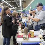 A vendor pours a sample for an attendee Saturday at the Winter Wine Festival in Elma. (Michael Lang | Grays Harbor News Group)