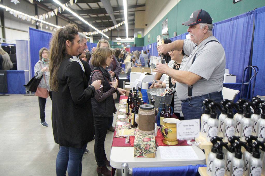 A vendor pours a sample for an attendee Saturday at the Winter Wine Festival in Elma. (Michael Lang | Grays Harbor News Group)