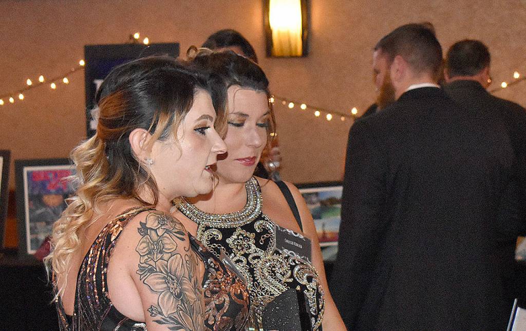 DAN HAMMOCK | GRAYS HARBOR NEWS GROUP                                Black and White Gala attendees check out the 12 live auction items Saturday up for bid at the annual United Way of Grays Harbor fundraiser.