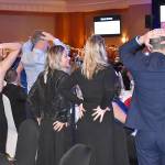 DAN HAMMOCK | GRAYS HARBOR NEWS GROUP                                Participants in the Heads or Tails fundraiser vie for 250 gallons of gasoline courtesy Masco Petroleum by grabbing their heads or, well, tails, as the auctioneer flips a coin until one person is left standing.