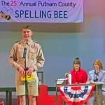 Chip Tolentino (Cody Garman) spells his word as Rona (Lily Darrin) and Vice Principal Panch (Jennifer Parks) look on.