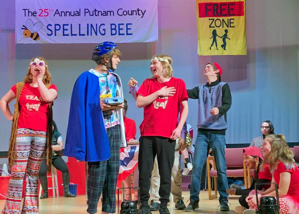 Leaf Coneybear (Christian Gleason, in blue) tells his family that he made it to the Bee. Also pictured, from left, are Makenna Catron, Jonas Stroup and Kaylen VanHousen.