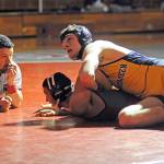 Aberdeens Seth Brown, top, takes a quick look at the clock in his 170-pound match against Hoquiams Joe Rodgers on Friday at Hoquiam High School. Brown would win the match via pinfall. (Ryan Sparks | Grays Harbor News Group)