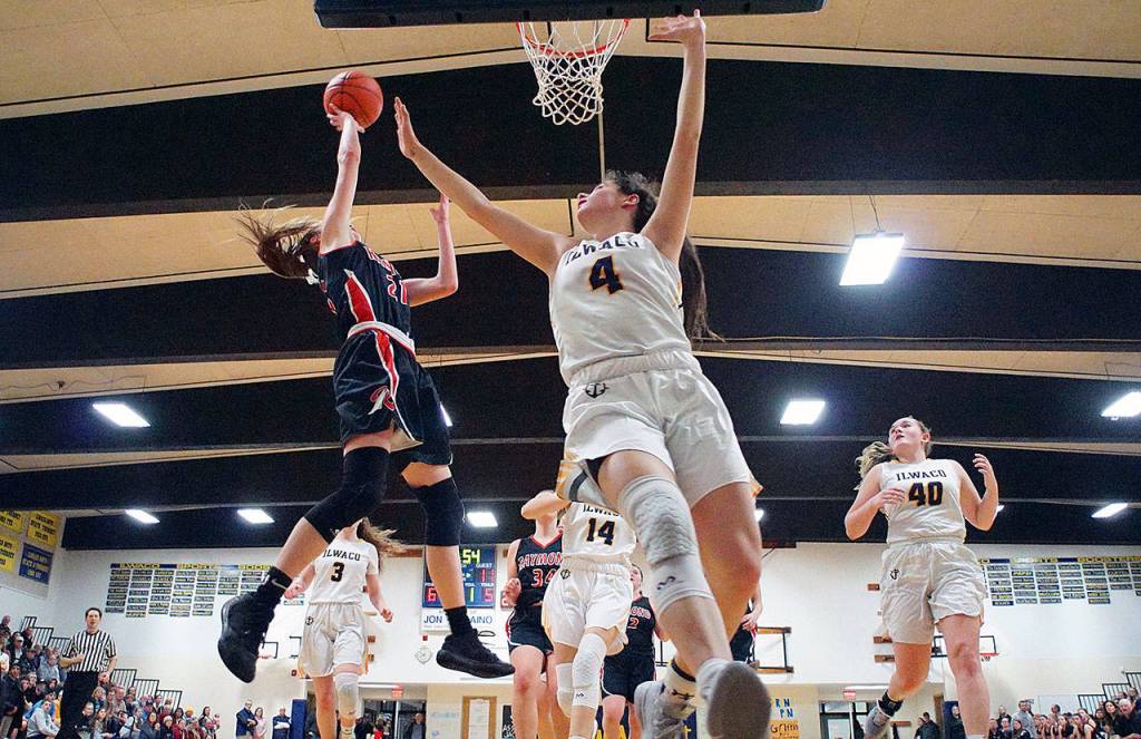 Raymonds Kyra Gardner, left, beats Erika Glenn (4) and the Ilwaco defense down the court for a layup during Fridays game at Ilwaco High School. (Photo by Rob Hilson)