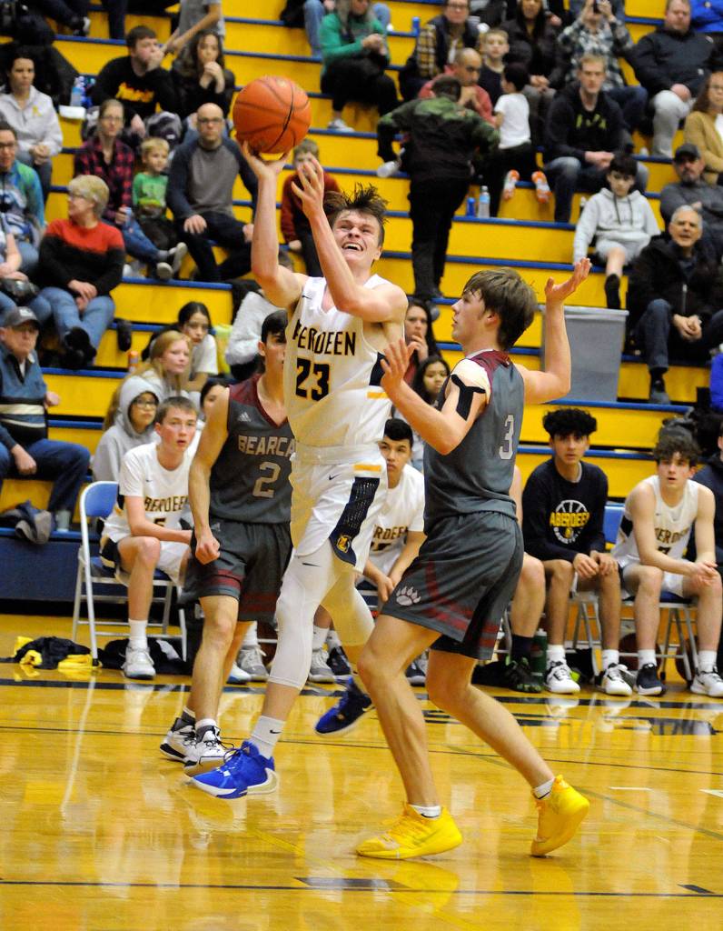 Aberdeens Wyatt Johnson (23) is fouled by WF Wests Carter McCoy during the Bobcats 54-48 loss to the Bearcats on Friday at Sam Benn Gym in Aberdeen. (Ryan Sparks | Grays Harbor News Group)