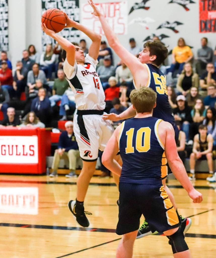 Photo by Larry Bale                                Raymonds Tre Seydel, left, shoots against Ilwacos Joe Nisbett during the Seagulls 73-52 loss to the Fishermen on Saturday in Raymond.