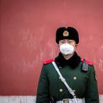 Nicolas Asfouri | AFP | Getty Images                                A paramilitary police officer wears a protective facemask as he stands guard at the exit of the Forbidden City in Beijing.