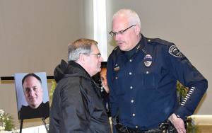 DAN HAMMOCK | GRAYS HARBOR NEWS GROUP                                 Hoquiam Police Chief Jeff Myers and retired Aberdeen Police officer Tom Siress talk after the memorial service for Hoquiam Police Officer Phil High Saturday in Ocean Shores.