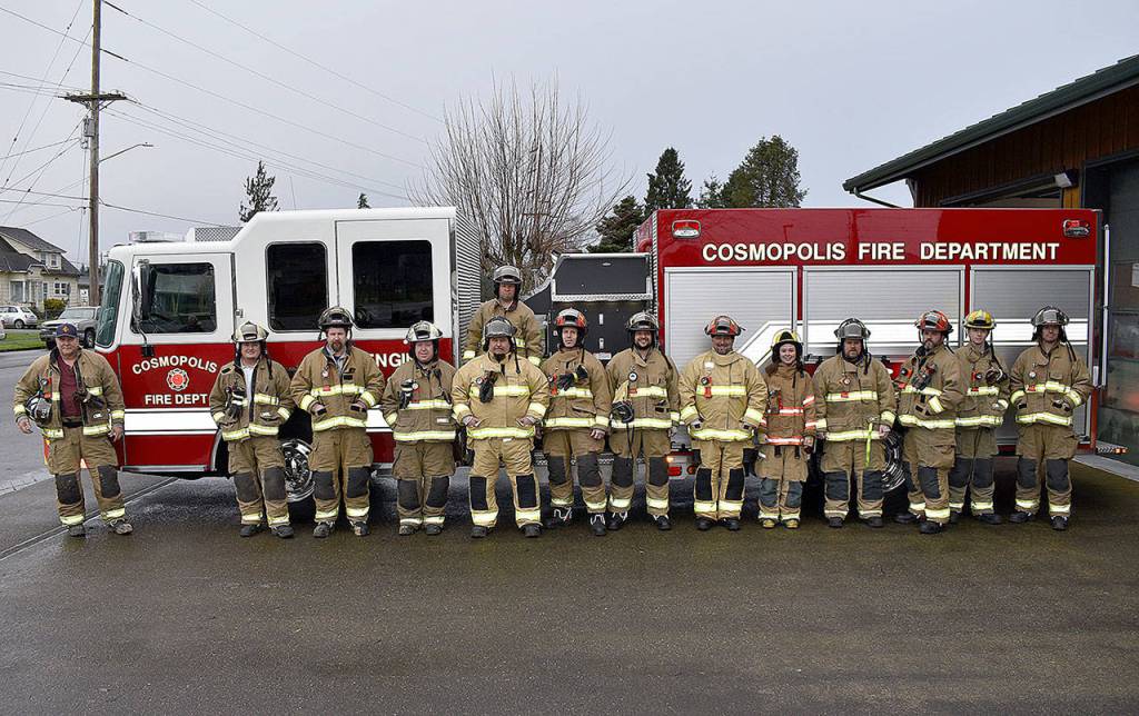 DAN HAMMOCK | GRAYS HARBOR NEWS GROUP                                 Cosmopolis firefighters pose with the departments new fire engine, unveiled Sunday morning.