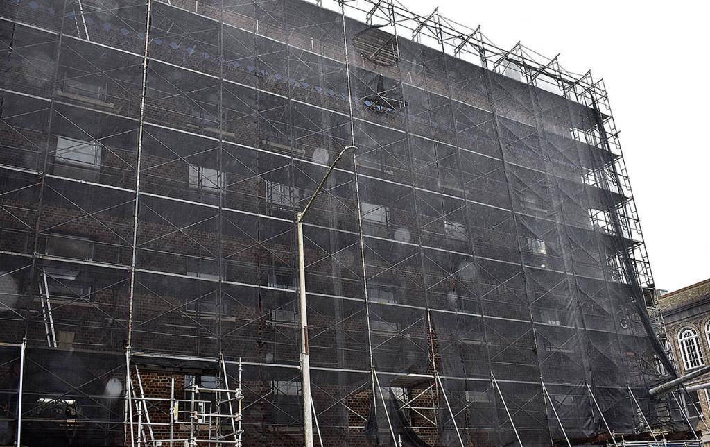 DAN HAMMOCK | GRAYS HARBOR NEWS GROUP                                 The scaffolding and sheeting hiding the brick exterior of Emerson Manor in Hoquiam started coming down Feb. 5 as a major renovation project reaches its conclusion.