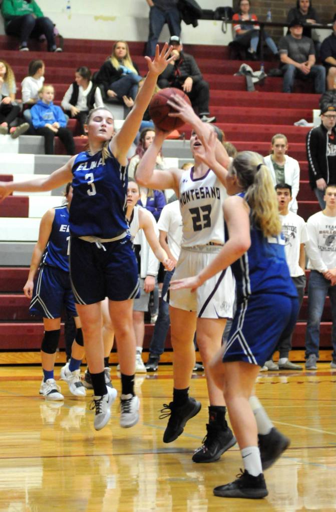 Elmas Jalyn Sackrider (3) and Quin Mikel defend a shot by Montesanos Paige Lisherness during the Eagles 60-52 win on Friday at Montesano High School. With the win, the Eagles clinched the No. 1 seed out of the 1A Evergreen League. (Ryan Sparks | Grays Harbor News Group)