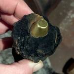 Last year, a person holds unexploded ammunition, likely from World War II anti-aircraft guns, that was found near Pacific Beach. The ordnance again has been found this year. (The Daily World file)