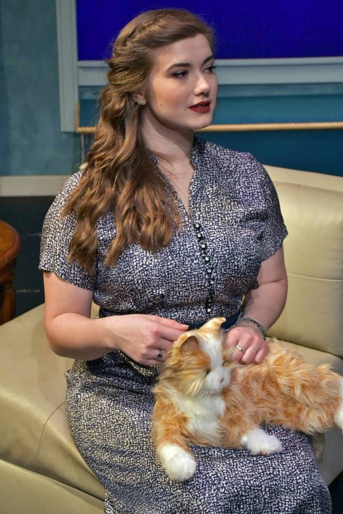 Gillian (Natasha Brown-Williams) strokes her familiar, Pyewacket, in Bell, Book and Candle.