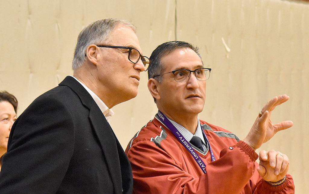 DAN HAMMOCK | GRAYS HARBOR NEWS GROUP                                 Hoquiam Superintendent Mike Villarreal, right, points out visiting students from the Quinault, Taholah and North Beach school districts to Gov. Jay Inslee at Hoquiam High School Wednesday.