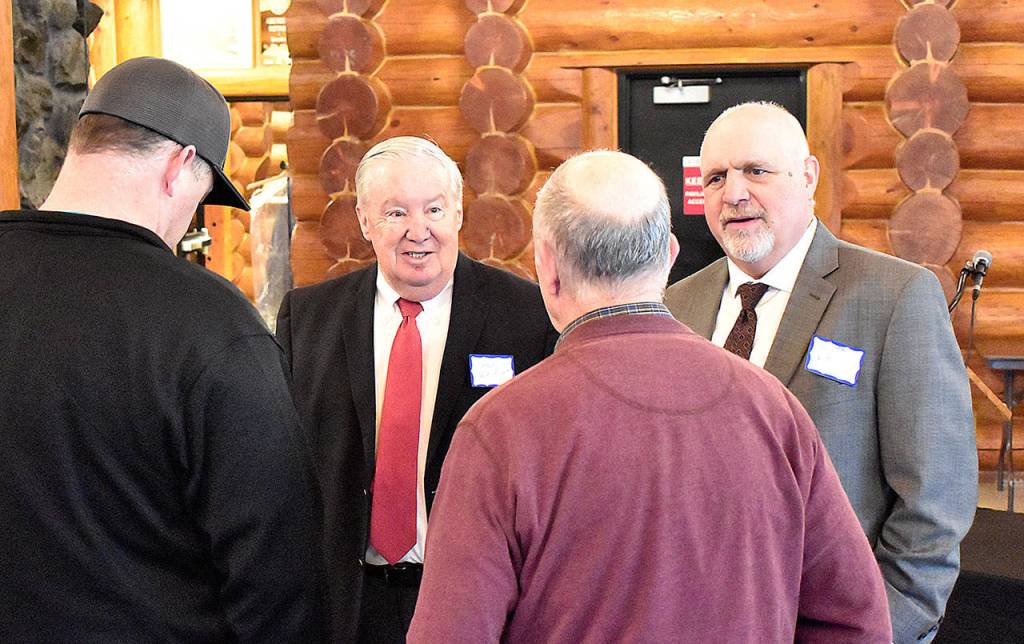 DAN HAMMOCK | GRAYS HARBOR NEWS GROUP                                 Port of Grays Harbor Commissioners Stan Pinnick, left, and Phil Papac chat with guests at the Ports annual business report breakfast at the Rotary Log Pavilion in Aberdeen Wednesday.