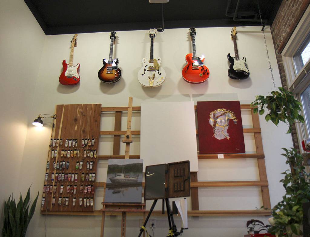 Guitars hang above Trina Moores painting area Jan. 29, 2020, at the Moore Gallery in Montesano. (Michael Lang | Grays Harbor News Group)