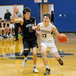 Aberdeens Gio Pisani (13) tries to shed the defense of Woodland guard Brady Burns during Aberdeens 58-54 play-in game loss on Thursday at Sam Benn Gym in Aberdeen. (Ryan Sparks | Grays Harbor News Group)