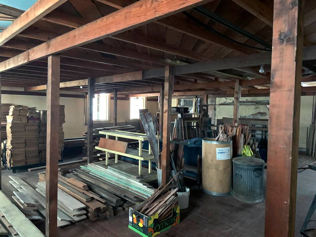 Stacks upon stacks of wood pieces are still crammed into the old ballroom from decades past.