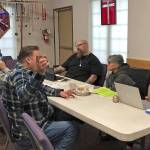 Photo courtesy Susan Conniry                                Service providers at the Jan. 23 event discuss the needs of a local woman whose utilities had been shut off.