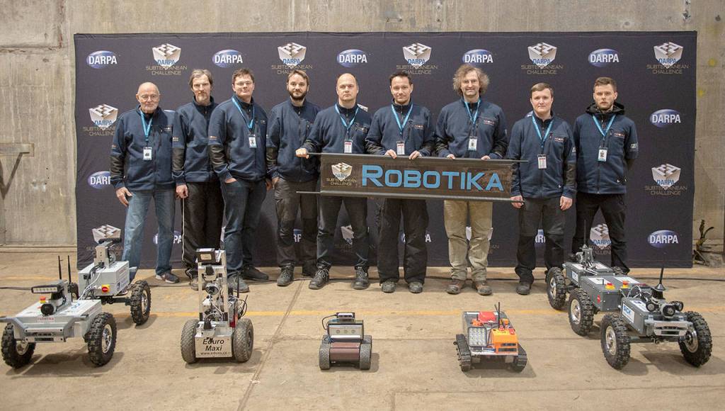Team Robotika  from universities and businesses in the Czech Republic, Switzerland and the United States  poses for a photo recently at the DARPA Subterranean Challenge Urban Circuit competition at the Satsop Business Park in Grays Harbor County. (Photo courtesy Defense Advanced Research Projects Agency)