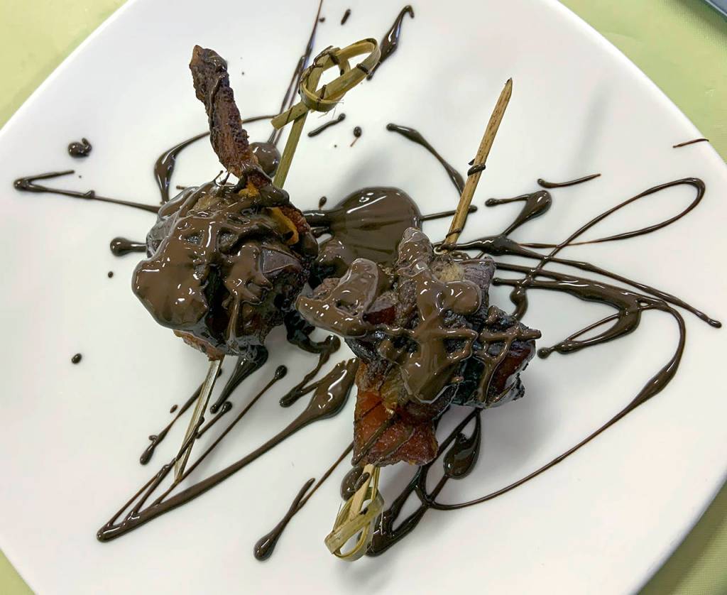 One of Ocean Crests stellar entries: a skewered date wrapped in bacon, stuffed with bleu cheese and drizzled with dark chocolate.