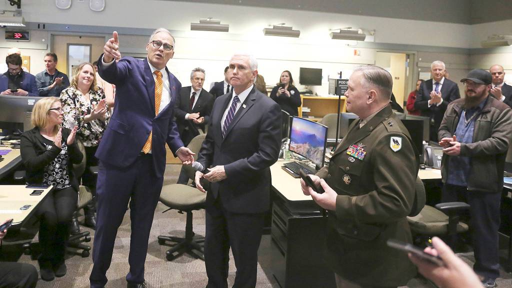 Photo by Steven Friederich                                 Gov. Jay Inslee, left, and Vice President Mike Pence address workers at the states Emergency Operations Center at Camp Murray on Thursday afternoon.