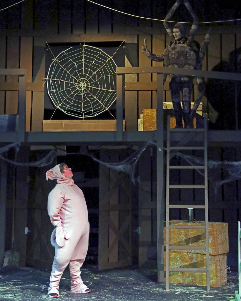 Charlotte (Mikaela Murphy) talks to Wilbur (Michael Turpin) in the barn.