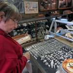 Photos by Kat Bryant | Grays Harbor News Group                                Darlene Burke, daughter of lifelong collector Dorothy Harrison, surveys one of the Shell Flair museum display cases that will be sold as a unit.