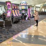 A woman uses a hand sanitizer station inside McCarran International Airport in Las Vegas. (Jay L. Clendenin/Los Angeles Times)