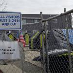 A notice attached to the front gate of the homeless camp behind Aberdeen City Hall on Tuesday said the camp was closed to all visitors until April 27 as a health precaution due to the virus outbreak. (Thorin Sprandel | Grays Harbor News Group)